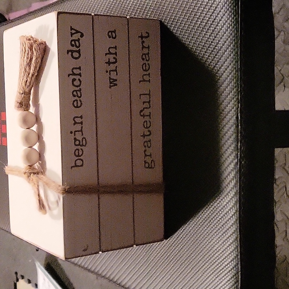 Decorative block with a saying on it